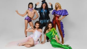 YUMMY production posing for photo in sequined, sparkly outfits