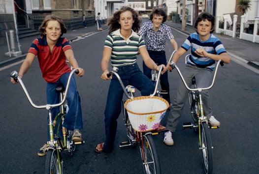 4 teens in 70s clothing on dragster bikes