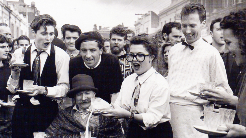 A black and white photo of the Waiters' Race, Brunswick St Parade, Fringe Festival 1988.