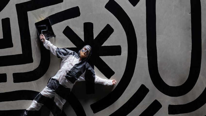 Man lying on black and white pattered ground
