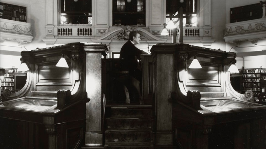 wooden dais with seated library attendant