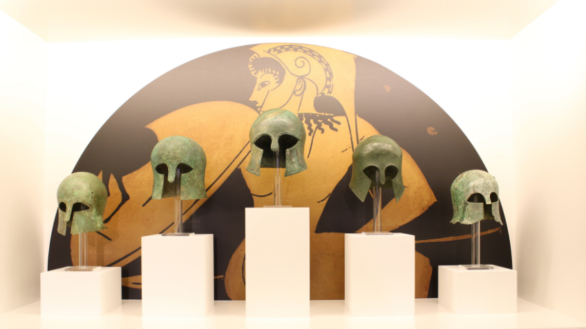 Display of cascading Ancient Greek helmets