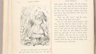 black and white photo of double-page spread from rare first edition copy of Lewis Carroll's Alice's Adventures in Wonderland featuring Tenniel's illustration of Alice with playing cards