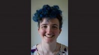 close up portrait of young female author with blue hair