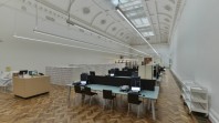 Gallery with high white coffered ceiling, parquet flooring and terminals