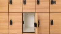 Rows of wood-panelled lockers with one locker door standing open