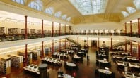heritage reading room with mezzanine balconies, glass roof, shelves of books and study tables