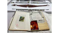 An open book with messy handwriting and images covering the pages