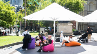 The Library forecourt on a sunny day with large umbrellas and bean bags in place