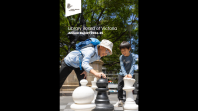 Front cover of the Library's 2024-25 Annual Report, which features an image of two children playing chess on the Library forecourt.