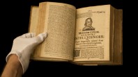 Colour photo of gloved hands holding open a rare copy of the early illustrated news sheet Mercurius Civicus Londons Intelligencer, London, 1643–46 