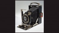 antique shutter camera on white background with black borders