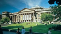 Colour photo of State Library Victoria facade and lawn on a sunny day