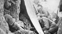 World War I soldiers take cover in a trench