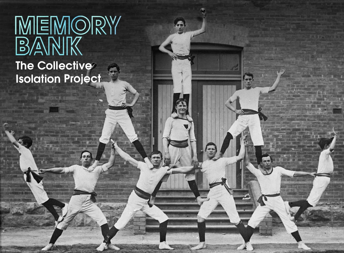 Eight men in white outfits support each other in a human pyramid