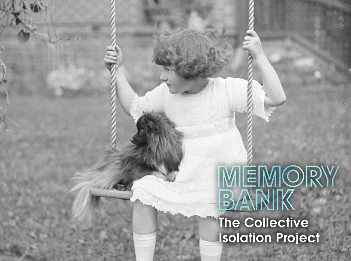 A little girl looks off to the distance as she sits on a swing with her puppy