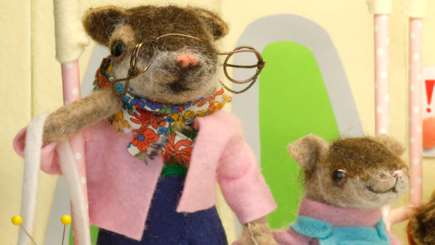 Furry creatures hand-crafted by Soft Stories standing on the Storyline express train