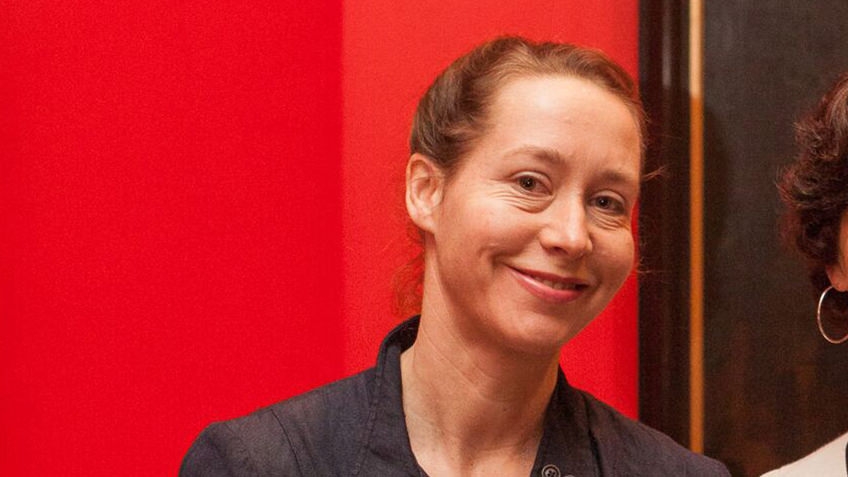 smiling woman against red background