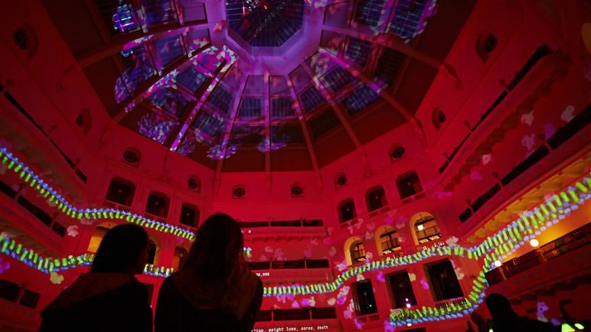 Interior of State Library Victoria's La Trober Reading Room during White Night with red projection covering the dome