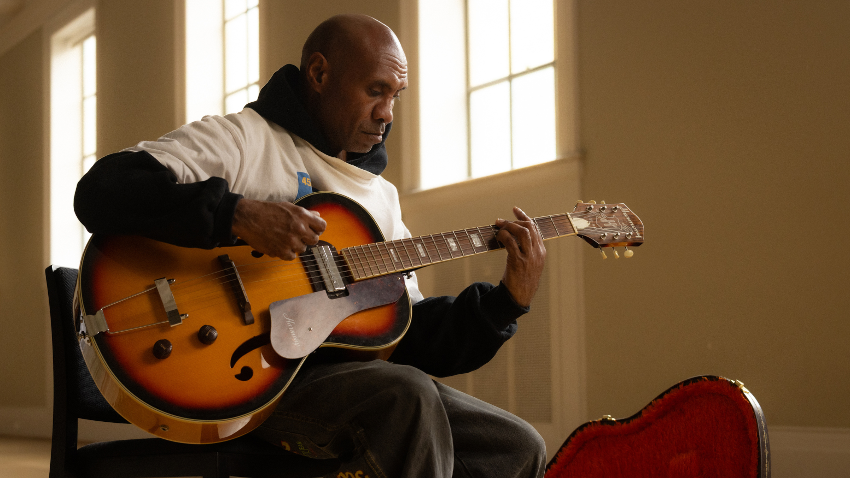Photo of Amos Roach playing guitar