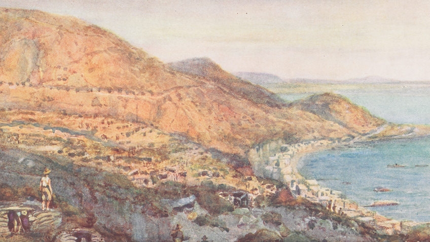 A rocky hill descends to a peaceful sea