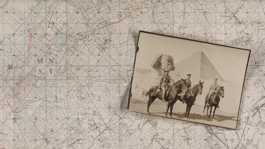 Three uniformed men pose on horses before the Sphinx and an Egyptian pyramid