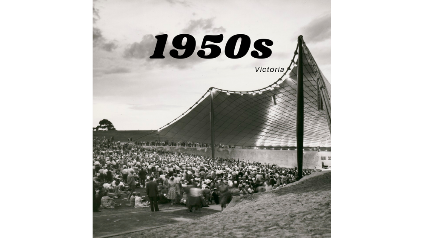 Black and white image of a crowd in front of a large structure