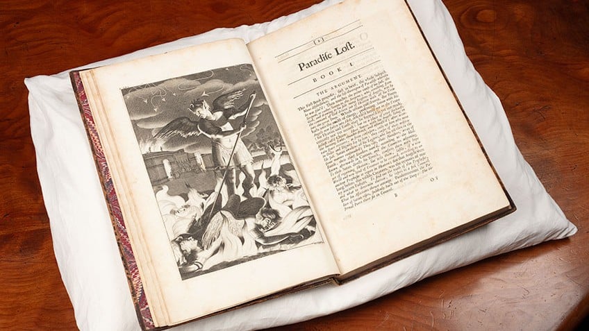 Image of opened rare edition of John Milton, Paradise lost, London, 1688 (first illustrated edition). The volume is placed on a white pillow on a brown table. On the left hand page is an illustration; on the right is the first page with headings stating Paradise Lost, Book 1.