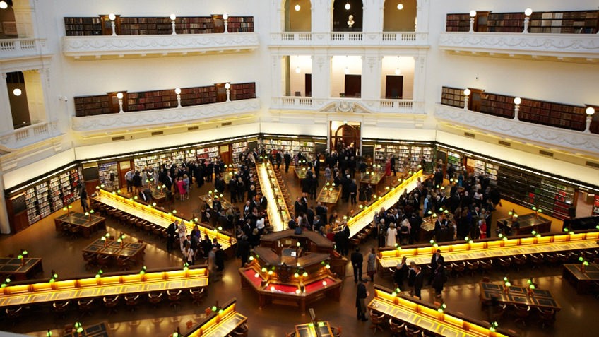 The La Trobe Reading Room desks are illuminated for an evening event