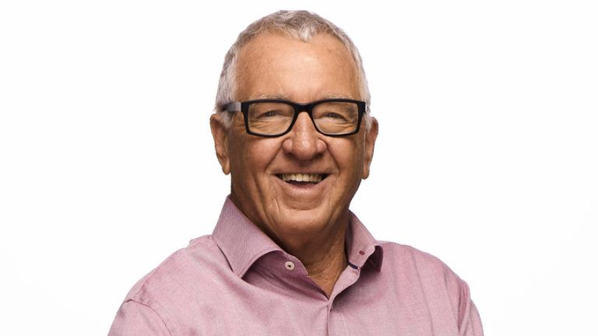 Image of Mike Sheahan, a man with short grey hair and spectacles and a button-up shirt.
