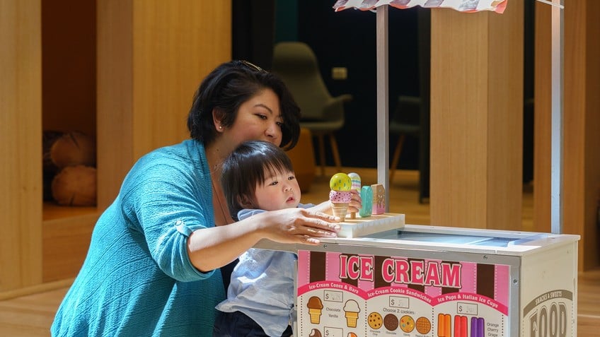 mother and child playing with toy ice cream
