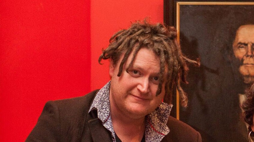 man with dreadlocks against a red background and oil painting