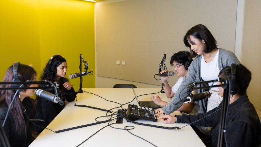 A group of university students working in the podcast room