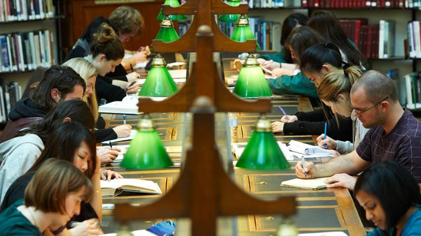 Library users researching in the La Trobe Reading Room