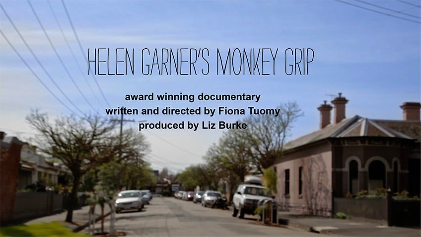 colour still from documentary about Helen Garner's Melbourne with inner-city backstreet with cars and terrace houses