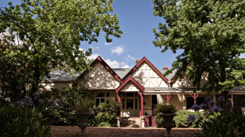 Colour photo of Dromkeen homestead, a federation-era timber home with stone steps and verandah