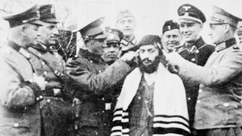 SS guards humiliating Orthodox Jewish man