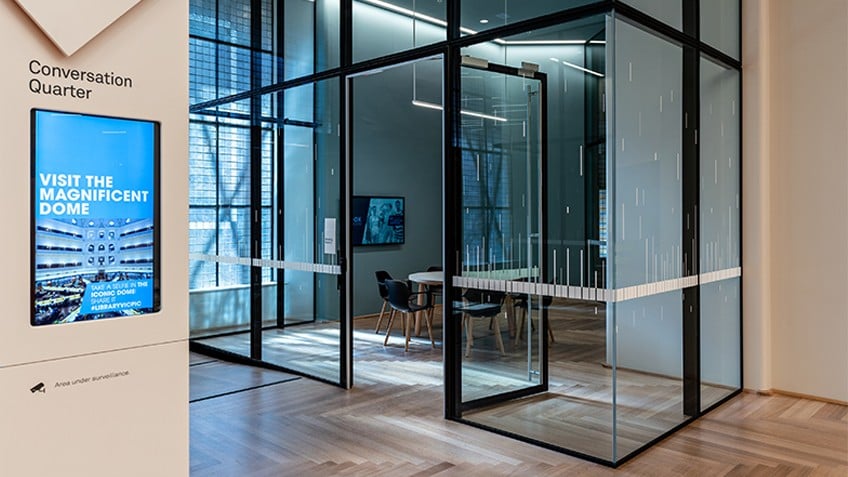 A meeting room with glass windows and doors