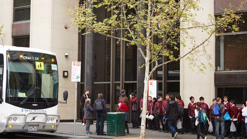 School students lining up outside the State Library's conference centre entrance on La Trobe Street