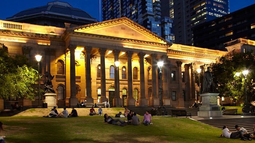 Library facade forecourt and lawns at night
