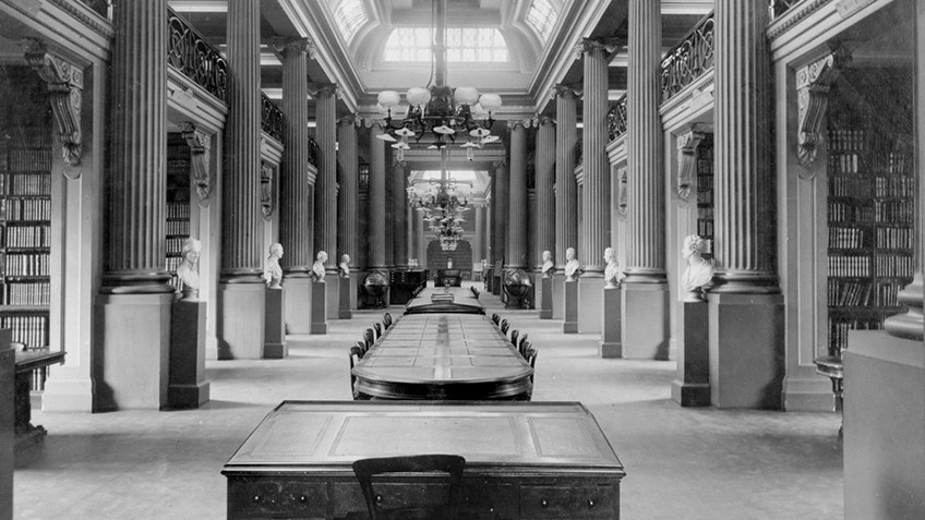 Black and white photo of columned interior of Queen's Hall, State Library Victoria, 1910