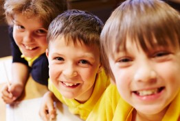 Smiling young schoolboys wearing yellow T-shirts