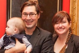 man and woman holding a baby against a red background and oil painting