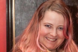 woman with blonde and pink hair against a red background and oil painting