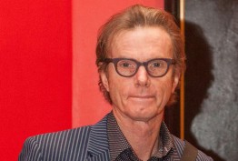 Martin King man with spectacles against red background