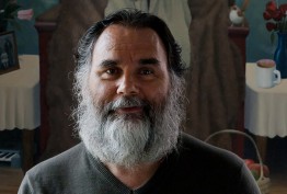 A bearded, smiling man
