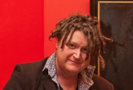man with dreadlocks against a red background and oil painting