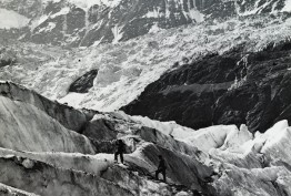 Mountaineers ascending snow covered alps, possibly in Switzerland Black and white photo of small group of mountaineers ascending snow covered alps, possibly in Switzerland, carrying walking sticks or mountain poles