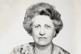 B&W headshot photo of middle-aged woman looking at camera without smiling