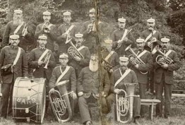 Black and white photo of members of Snitterfield brass band seated and holding musical instruments 1880s